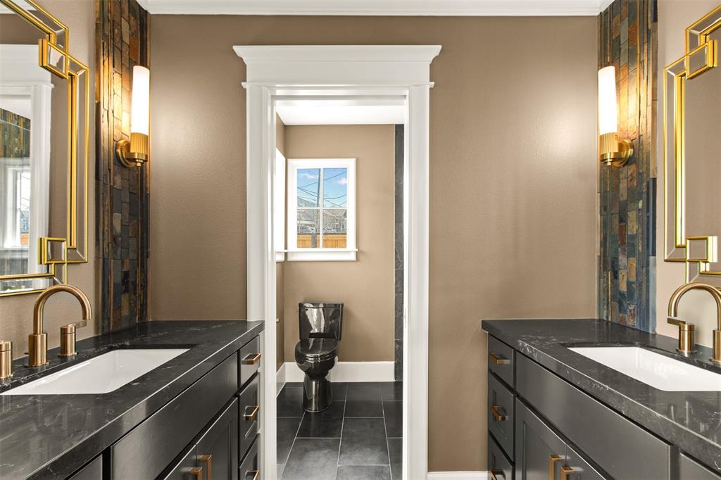 5230 Homer Street Dallas, TX 75206 - Photo 17 of 39 a bathroom with a granite countertop sink a toilet and a mirror