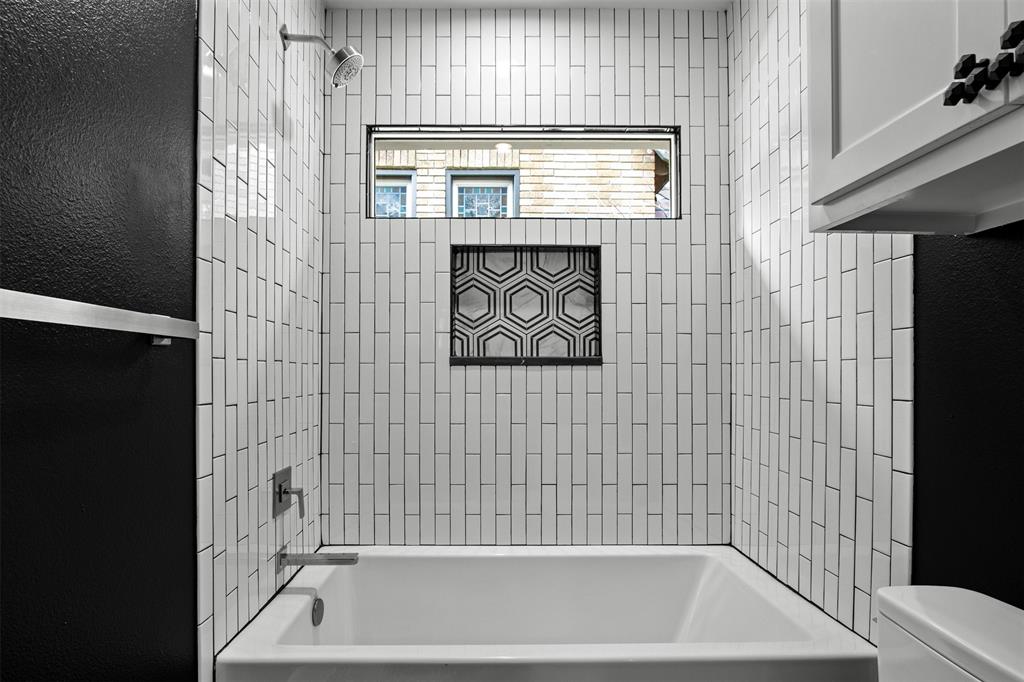 5230 Homer Street Dallas, TX 75206 - Photo 27 of 39 a bathroom with a bathtub and a shower