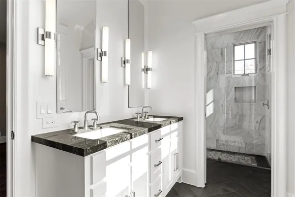 a bathroom with a granite countertop sink and a mirror
