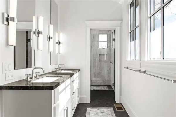 a bathroom with a granite countertop sink and a mirror