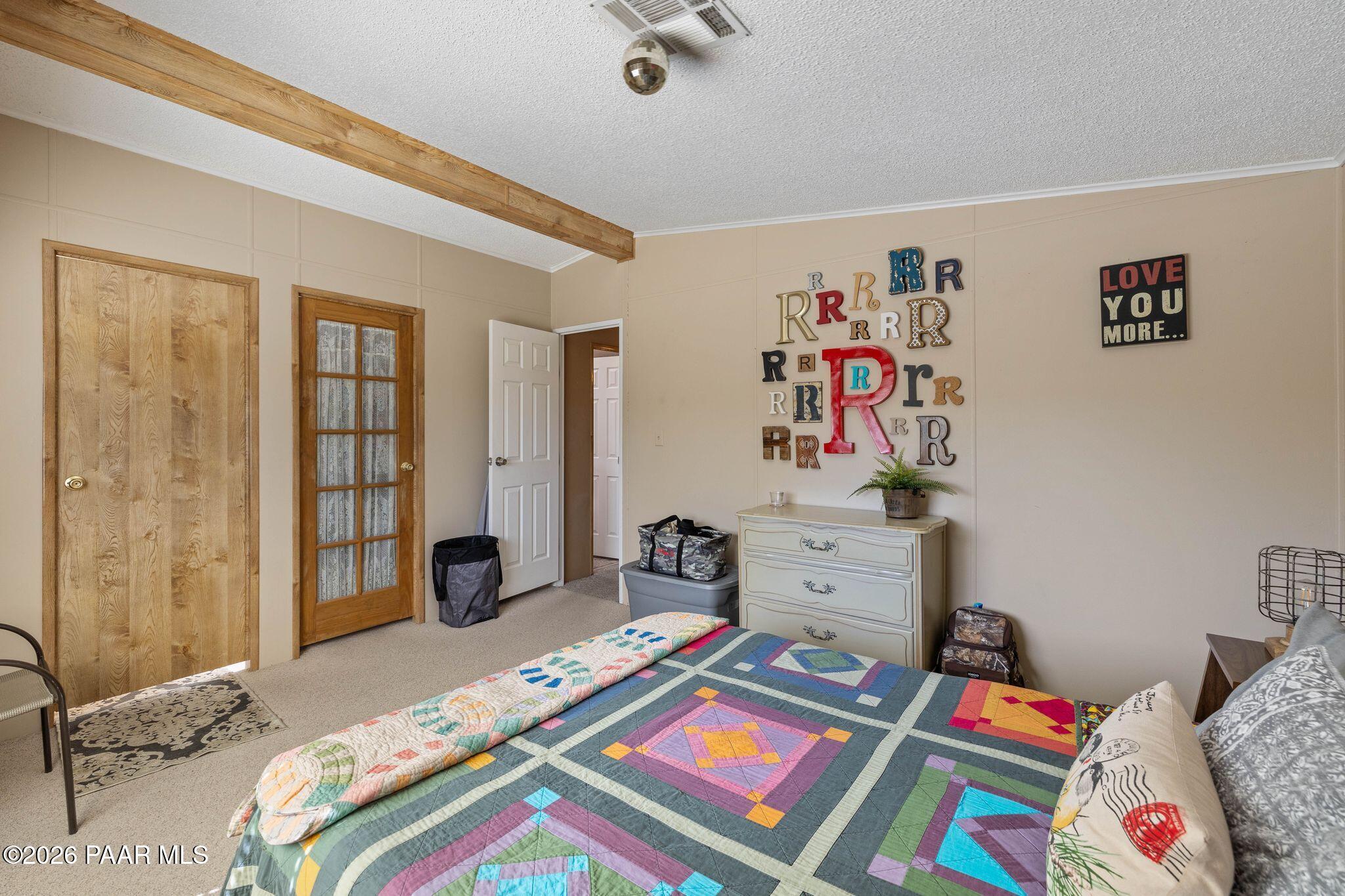 10194 East Durham Road Dewey, AZ 86327 - Photo 20 of 47 a bed room with a bed and a couch