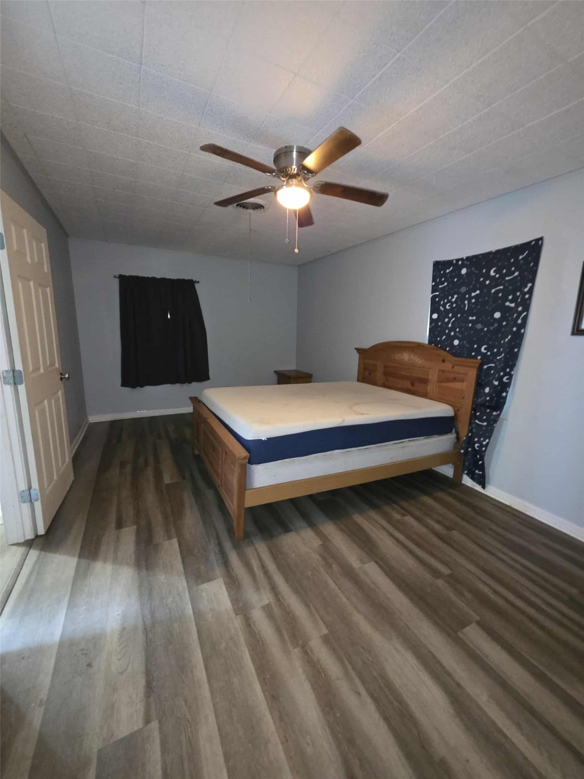 115 Bell Street Point Comfort, TX 77978 - Photo 15 of 24 a bedroom with a bed and a chandelier