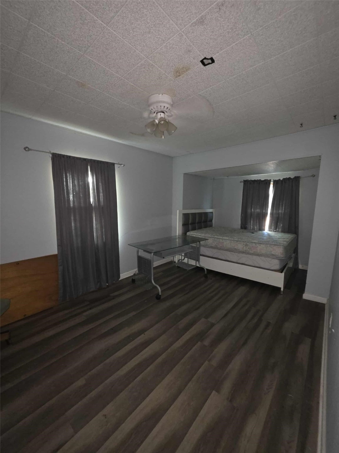 115 Bell Street Point Comfort, TX 77978 - Photo 21 of 24 a bedroom with a bed and wooden floor