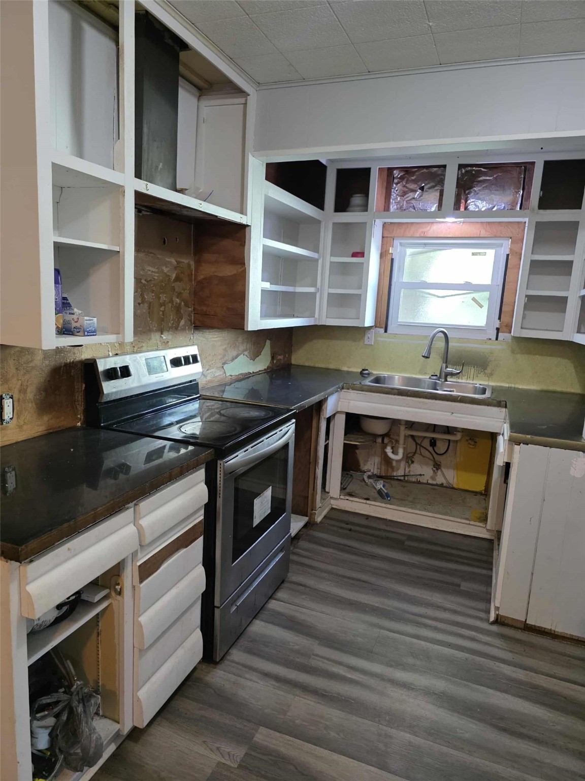115 Bell Street Point Comfort, TX 77978 - Photo 24 of 24 a kitchen with stainless steel appliances granite countertop a stove a sink and a microwave