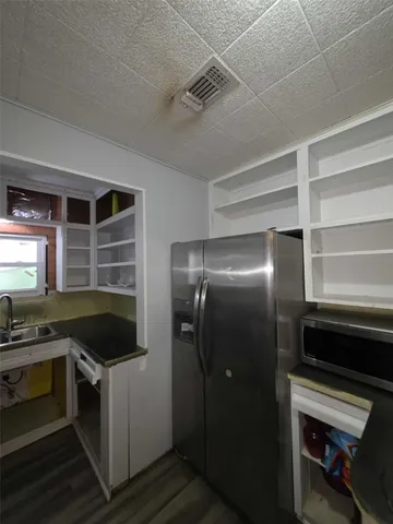 a kitchen with a refrigerator and a stove