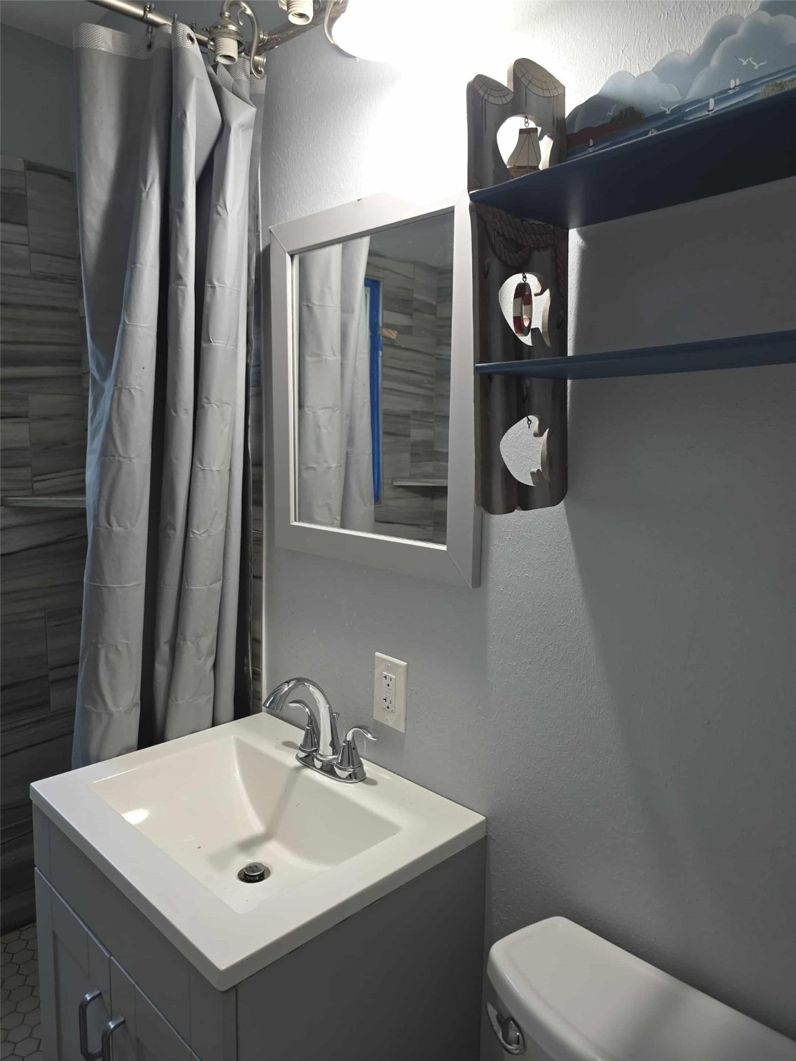 115 Bell Street Point Comfort, TX 77978 - Photo 9 of 24 a bathroom with a toilet sink and mirror