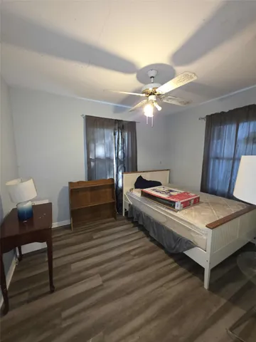 a bedroom with bed and a chandelier