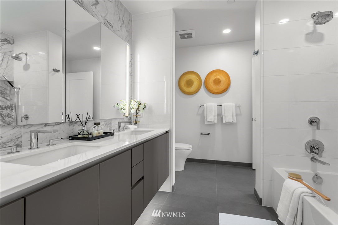 2510 6th Avenue, Unit 1409 Seattle, WA 98121 - Photo 15 of 35 a bathroom with a sink and a mirror