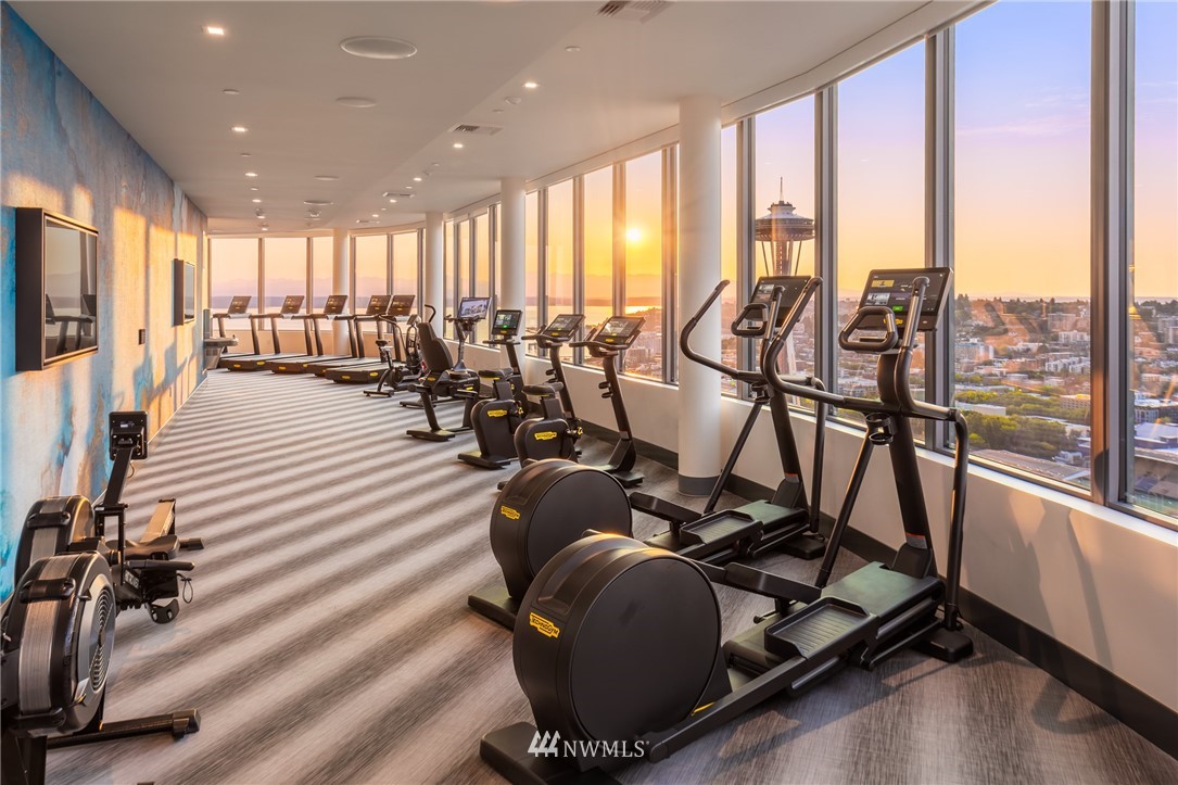 2510 6th Avenue, Unit 1409 Seattle, WA 98121 - Photo 22 of 35 a room with gym equipment and floor to ceiling window