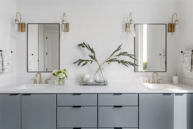 a bathroom with a sink and mirror