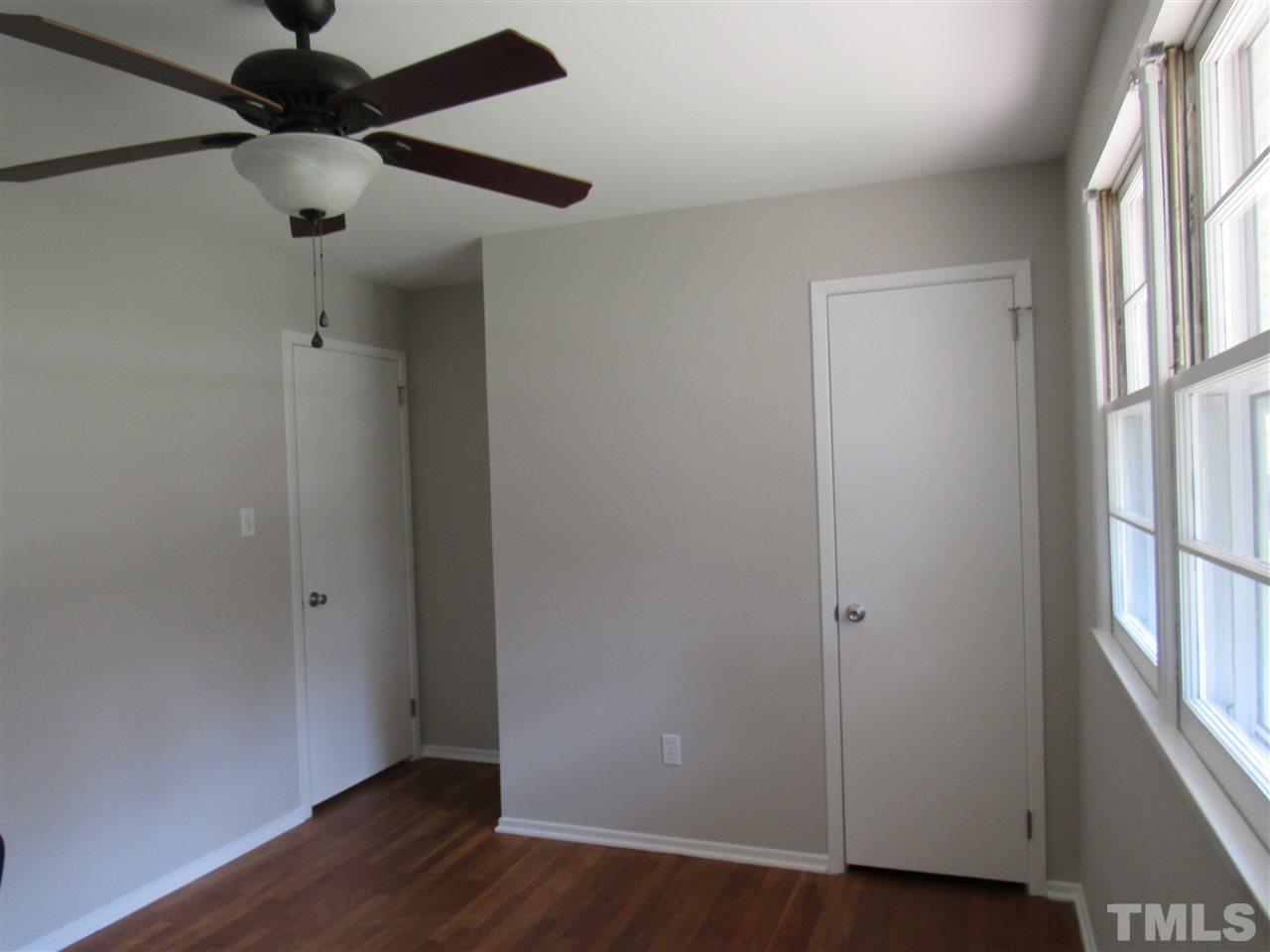 321 Quail Drive Raleigh, NC 27604 - Photo 15 of 25 a view of an empty room with wooden floor and a window