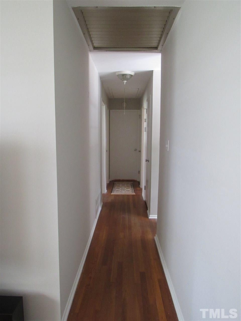 321 Quail Drive Raleigh, NC 27604 - Photo 20 of 25 a view of a hallway with wooden floor