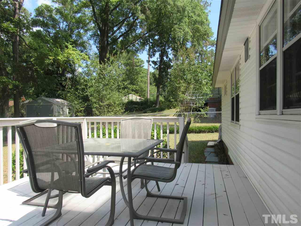 321 Quail Drive Raleigh, NC 27604 - Photo 21 of 25 a balcony with wooden floor table and chairs