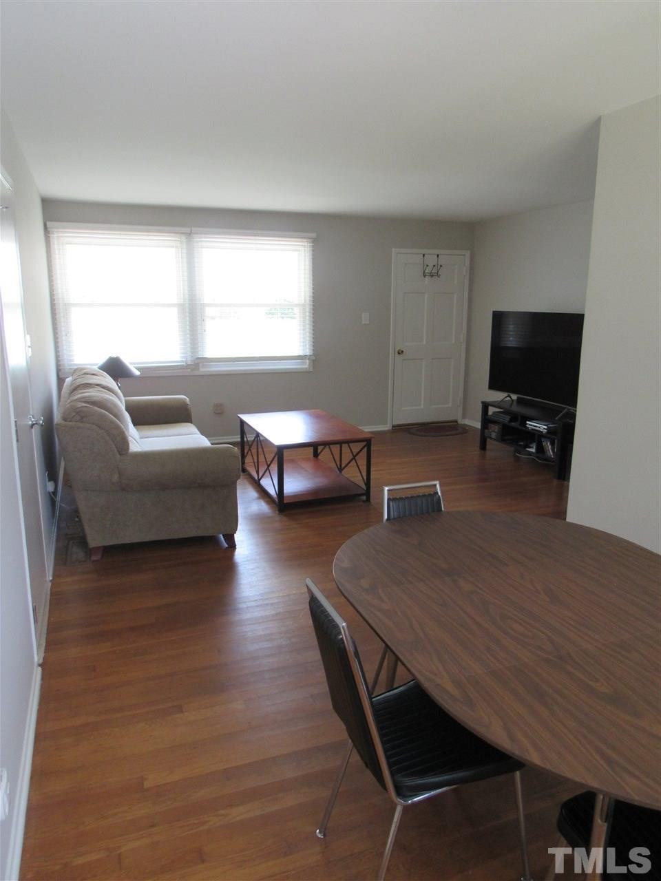 321 Quail Drive Raleigh, NC 27604 - Photo 5 of 25 a living room with furniture and a flat screen tv