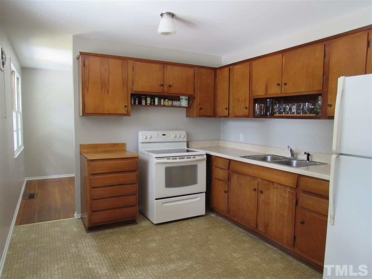321 Quail Drive Raleigh, NC 27604 - Photo 8 of 25 a kitchen with stainless steel appliances a stove a sink and a refrigerator