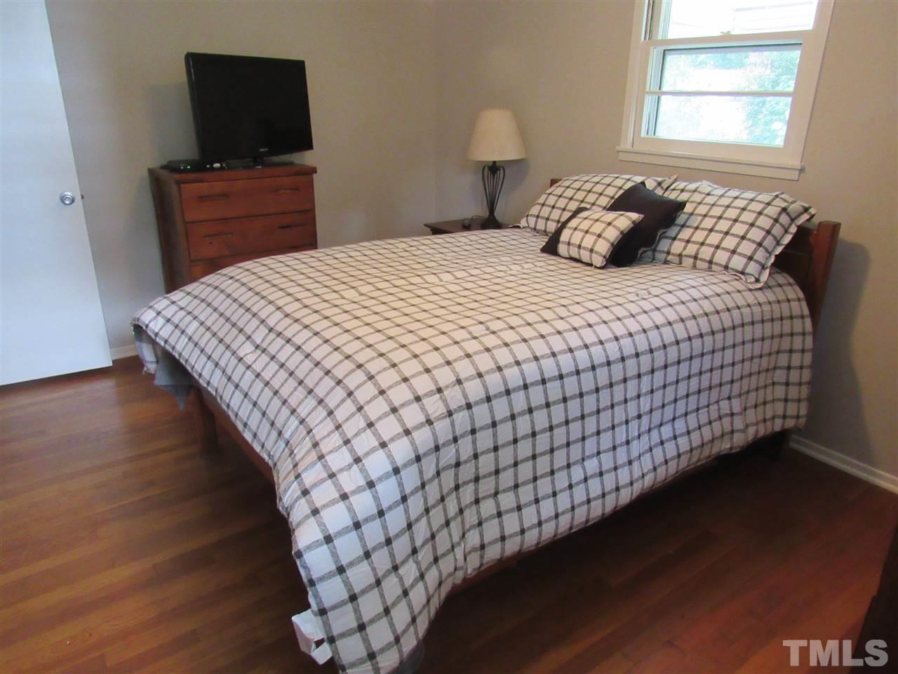 321 Quail Drive Raleigh, NC 27604 - Photo 10 of 25 a bedroom with a bed and a flat screen tv