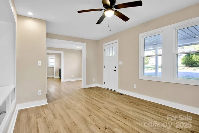 wooden floor in an empty room with a window