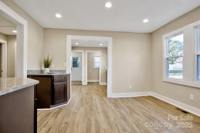 a kitchen with granite countertop a refrigerator and a sink