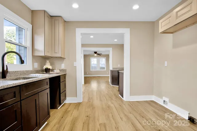 a view of a kitchen from the hallway with a sink