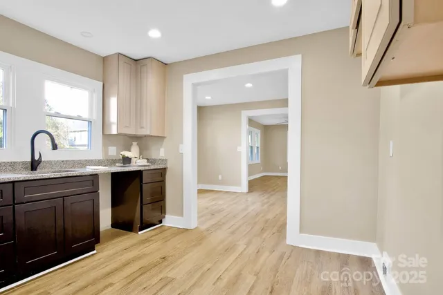 a kitchen with wooden floors and cabinets