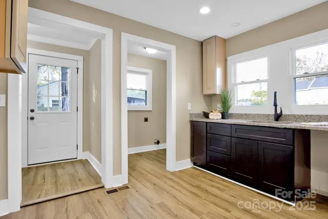 a spacious bathroom with a granite countertop sink and a mirror
