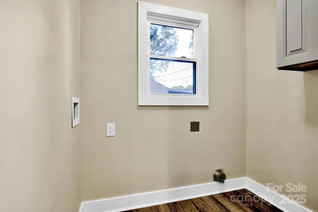 a view of a hallway with wooden floor and a window