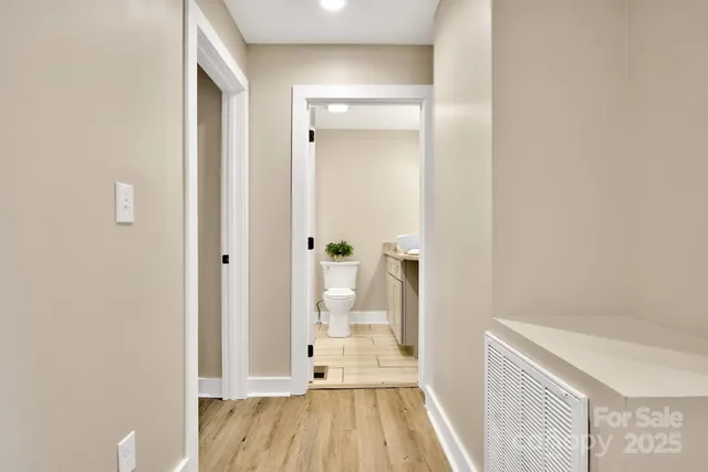 a white toilet sitting next to a bathroom sink and tub