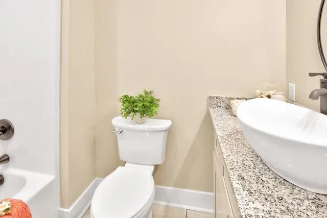 a bathroom with a toilet a sink and a mirror