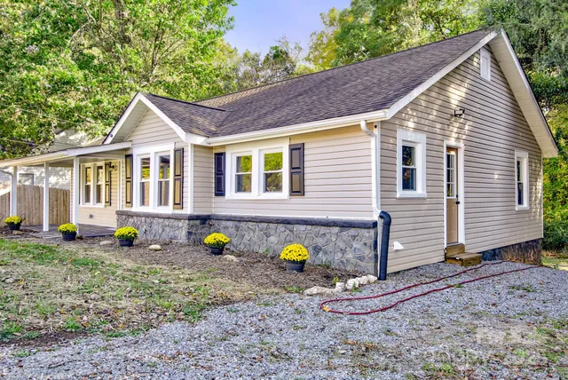 a front view of house with a garden