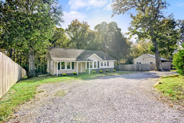 a front view of house with yard and green space