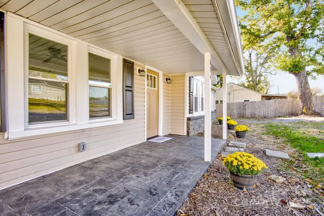 a view of a house with backyard and sitting area