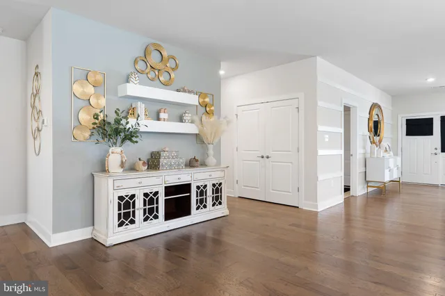 a view of kitchen with stainless steel appliances granite countertop a stove a sink a refrigerator and wooden floor