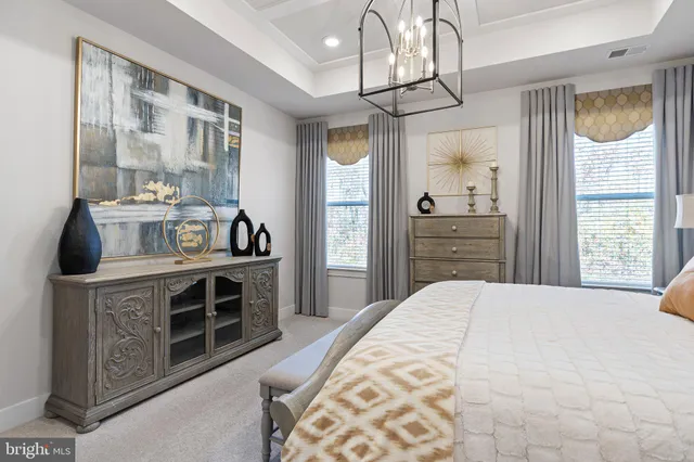 a spacious bedroom with a bed and a dresser