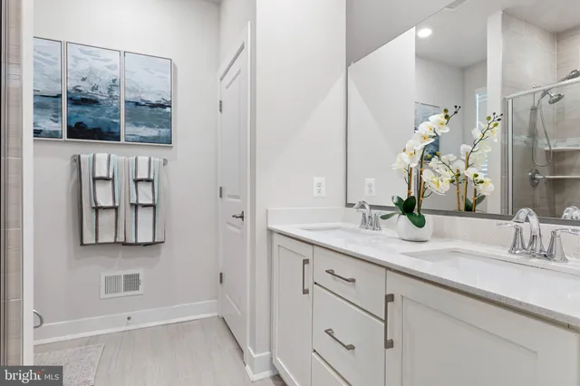 a bathroom with a double vanity sink and a mirror