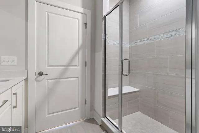 a bathroom with a glass shower door