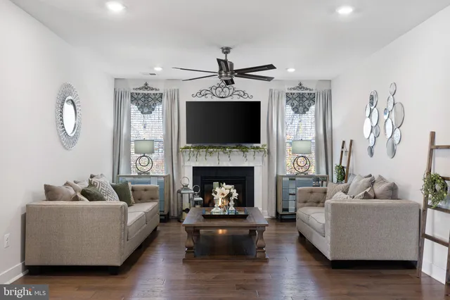 a living room with furniture a fireplace and a flat screen tv