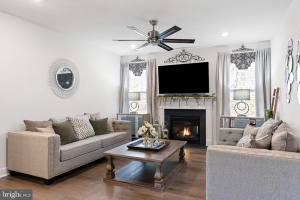 a living room with furniture a fireplace and a flat screen tv