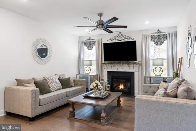 a living room with furniture a fireplace and a flat screen tv