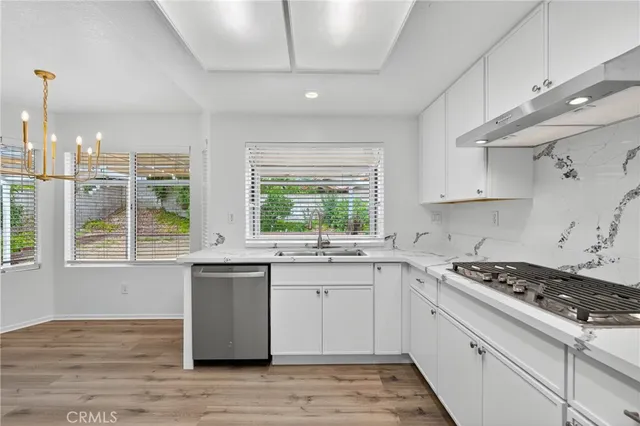 a kitchen with a sink stove and cabinets