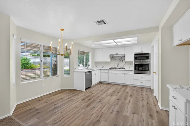a kitchen with stainless steel appliances a refrigerator sink and cabinets
