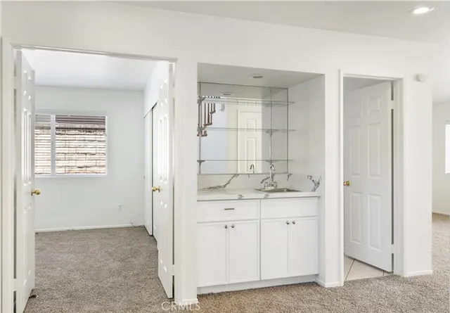 a bathroom with a granite countertop sink a mirror and a