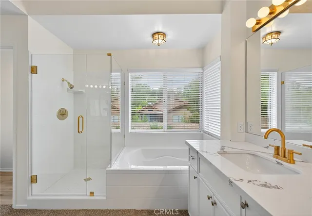 a bathroom with a tub sink and mirror