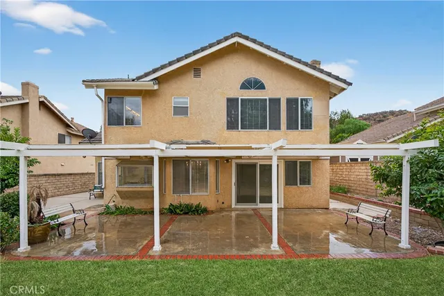 a outdoor space with the couches and a potted plant