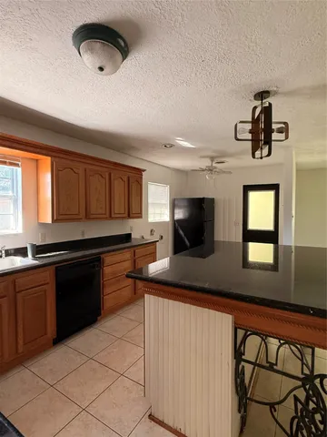 a kitchen with a sink stainless steel appliances and cabinets