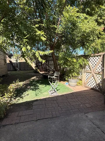 a view of backyard with wooden fence