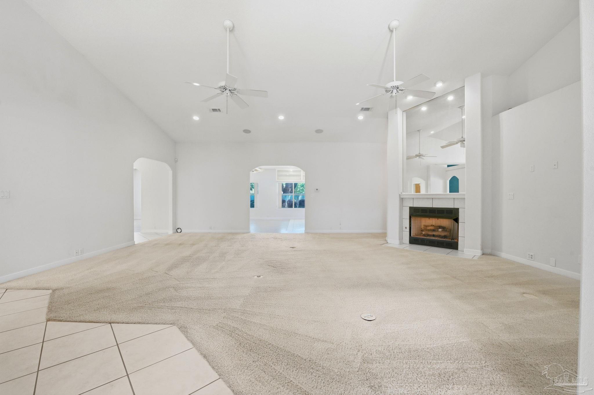 4552 Peaden Road Pace, FL 32571 - Photo 10 of 38 an empty room with a fireplace and fan