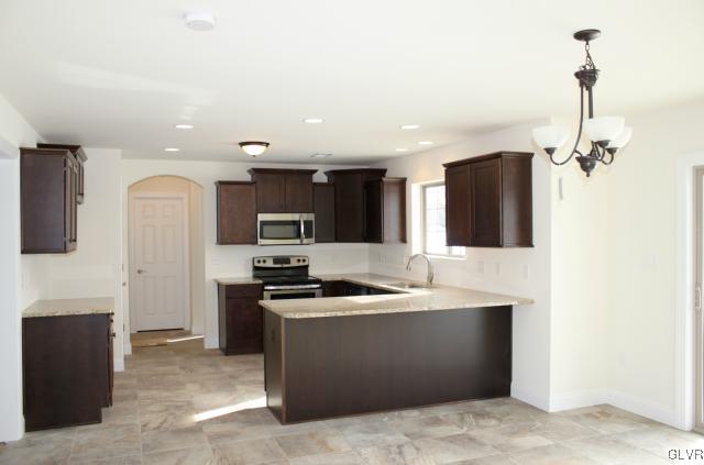 205 East Dell Road Bath, PA 18014 - Photo 2 of 14 a kitchen with stainless steel appliances granite countertop a sink and a refrigerator