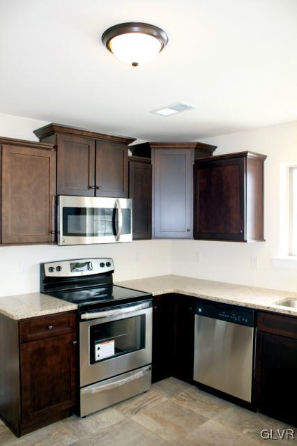 205 East Dell Road Bath, PA 18014 - Photo 3 of 14 a kitchen with stainless steel appliances kitchen island a stove and a sink
