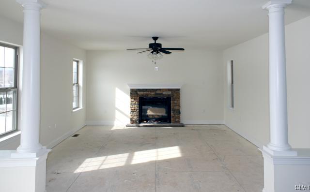 205 East Dell Road Bath, PA 18014 - Photo 5 of 14 a view of a livingroom with a fireplace and a ceiling fan