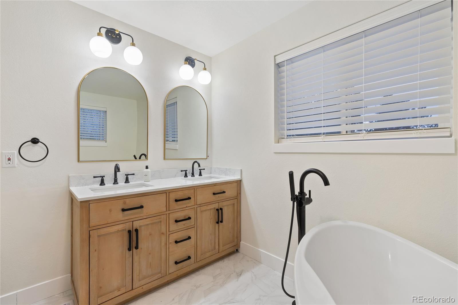 29 South Pine Drive Bailey, CO 80421 - Photo 14 of 27 a bathroom with a double vanity sink and a mirror